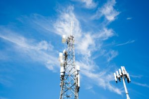 Radio, communication and cell towers on blue sky background