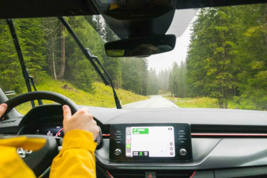 Tourist drives car through pass in Alps