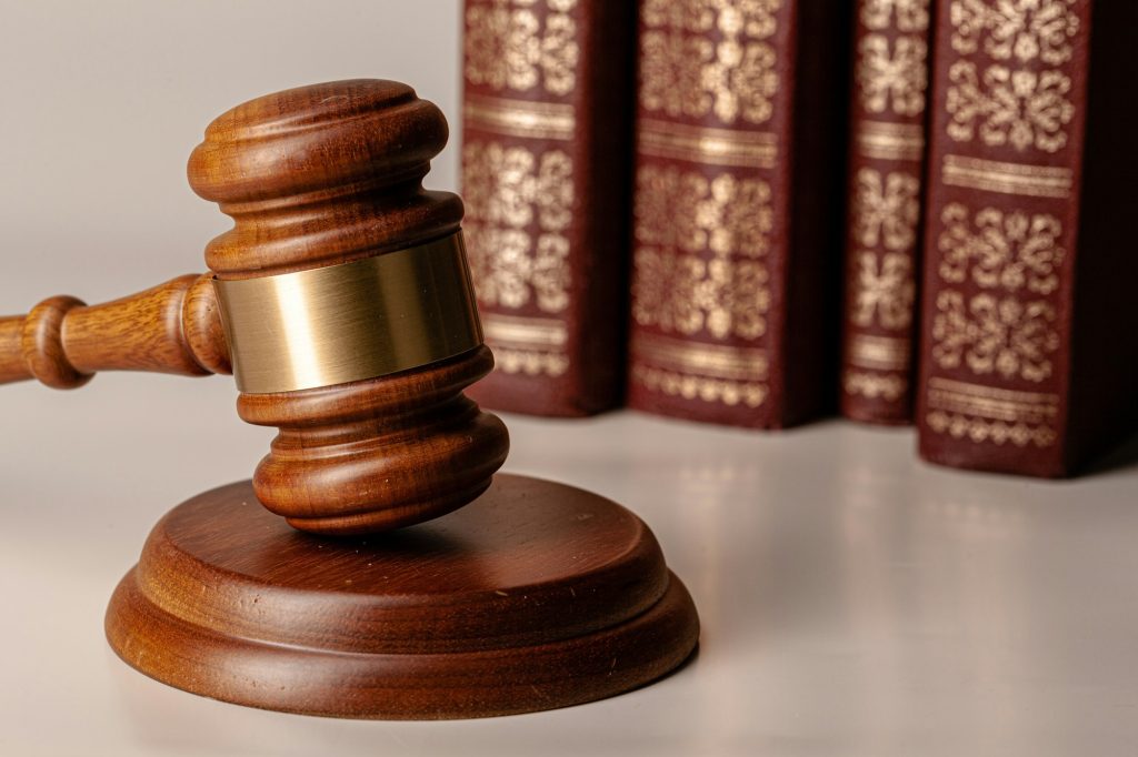 Judge gavel and legal book close up on table