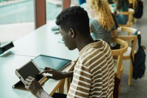 Young multiethnic group of students studying inside university library