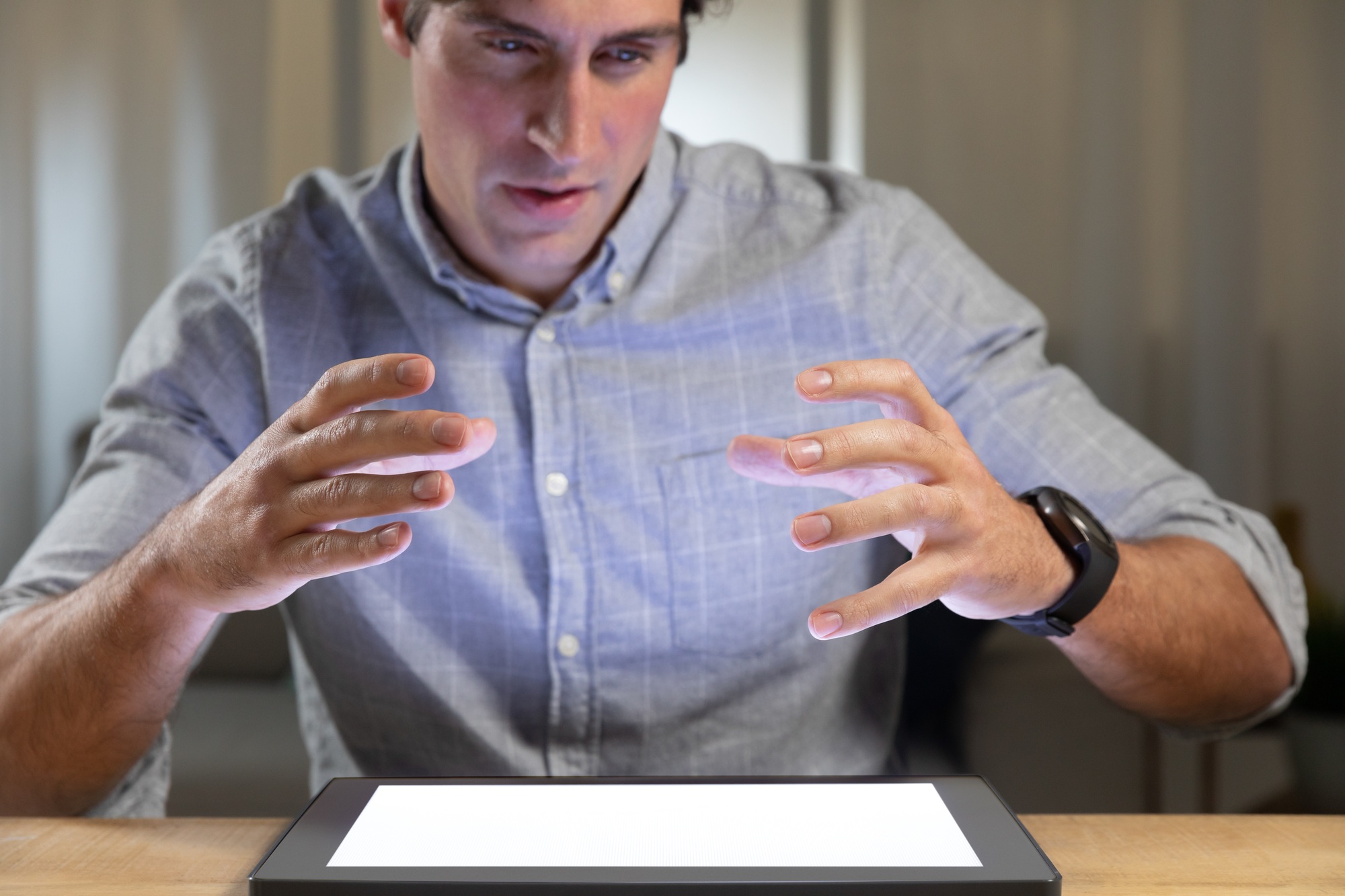 Young man using tablet computer on a table